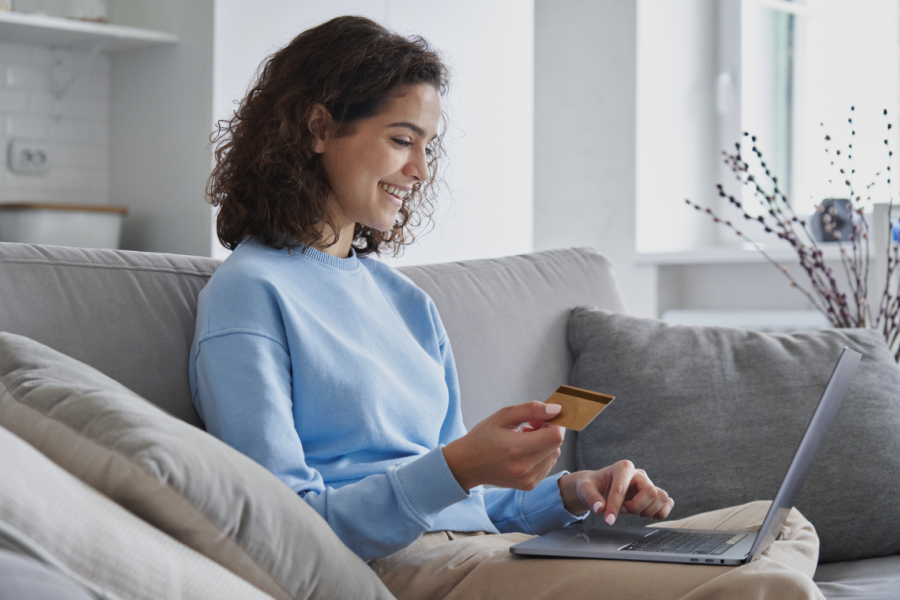 Woman using a laptop and credit card for online shopping or payment