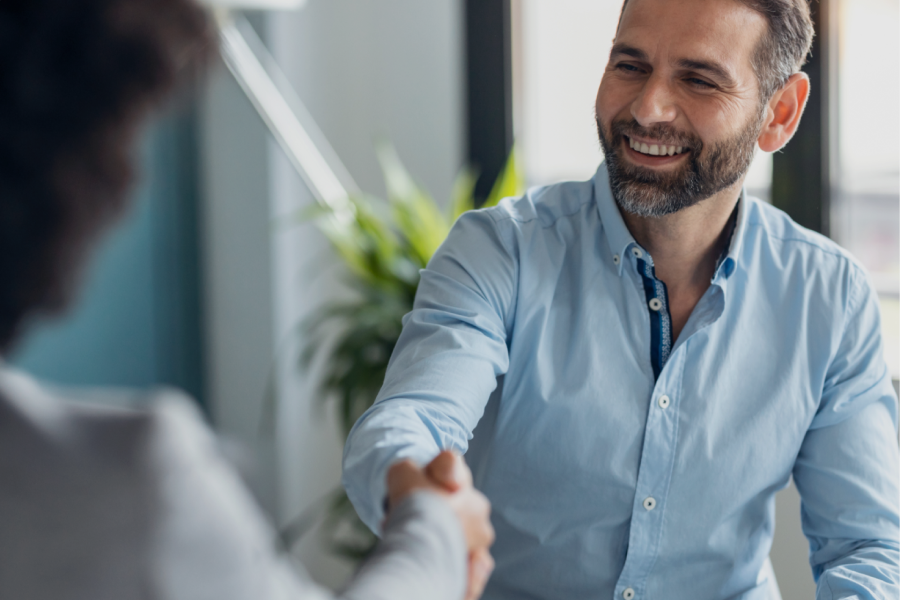 Two men shaking hands in a gesture of agreement or partnership